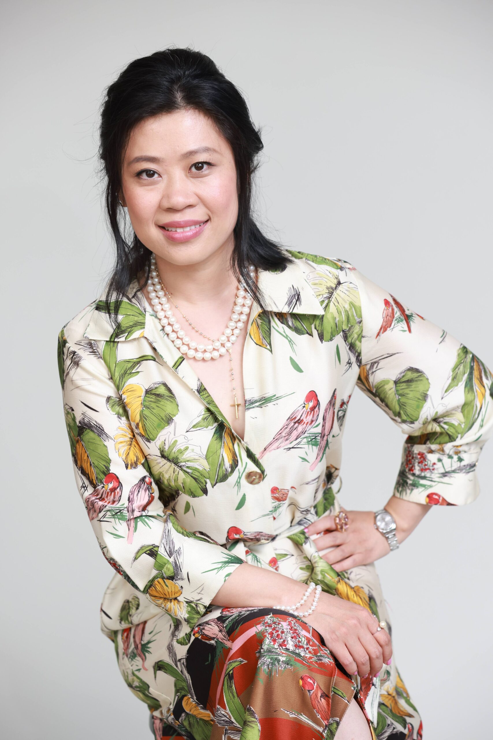 Woman in floral dress, smiling