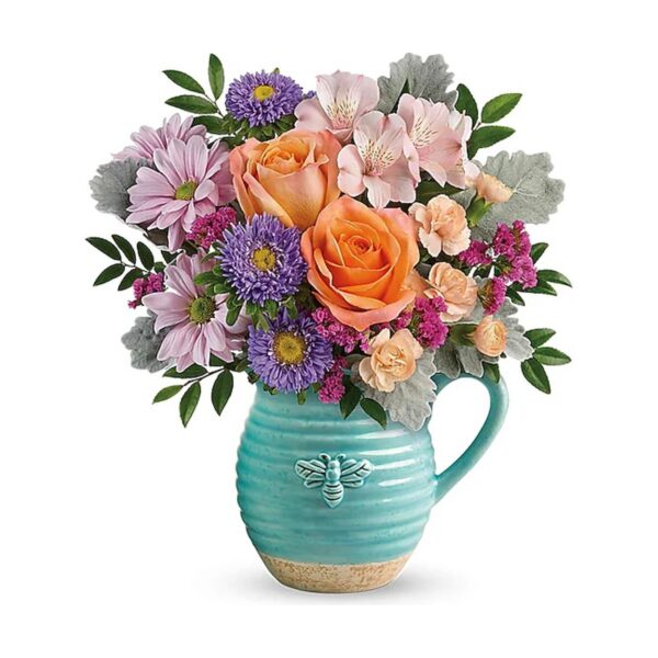 Colorful flowers in a pitcher vase.