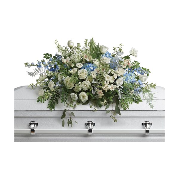 Floral arrangement on white casket