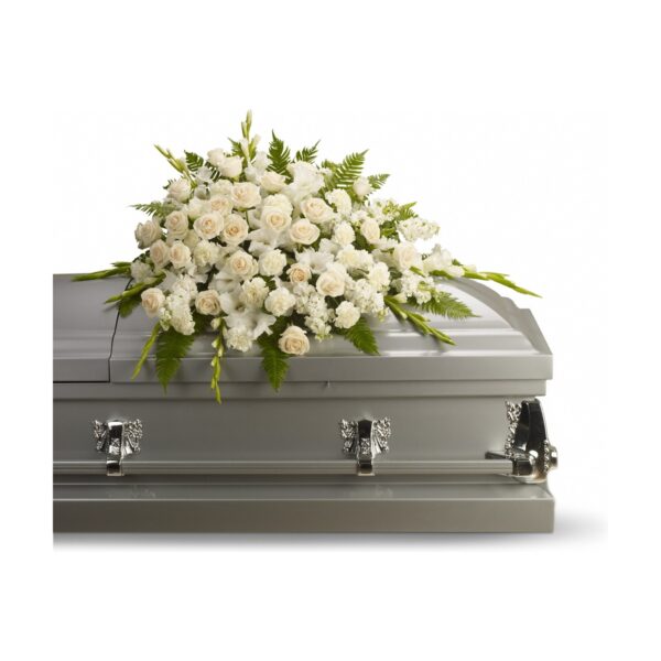 Coffin adorned with white flowers.