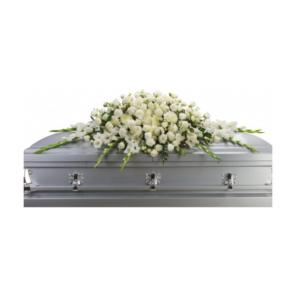 Coffin adorned with white flowers.