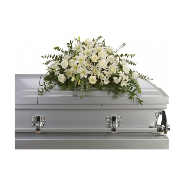 Coffin adorned with white flowers.